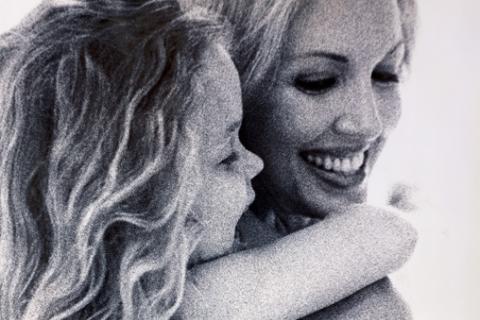 Mother giving daughter piggy back ride