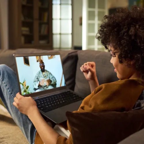 Young boy on a videocall with his father in the military. 