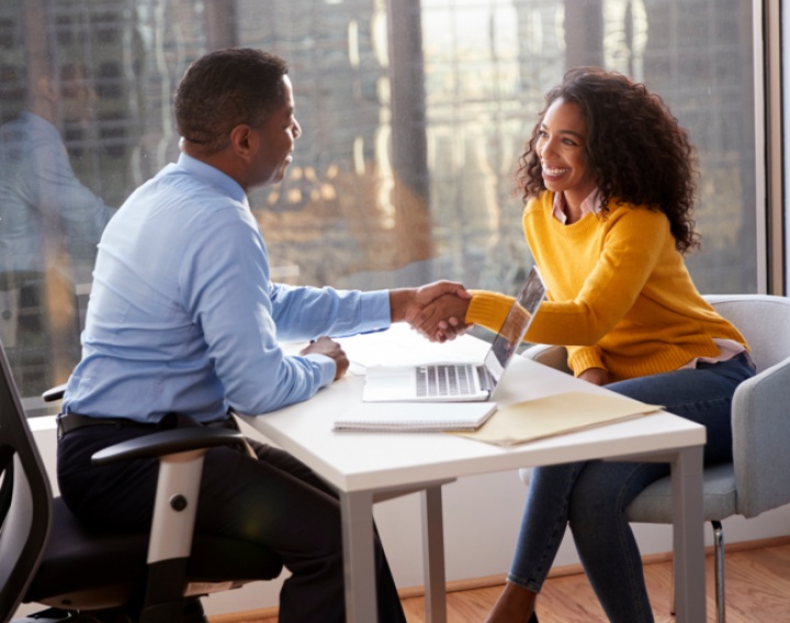 A parent shakes the hand of their family law professional as they work together.