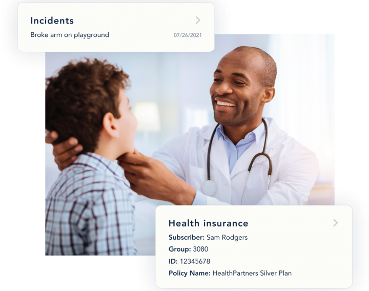 A doctor smiles as he examines a young patient.