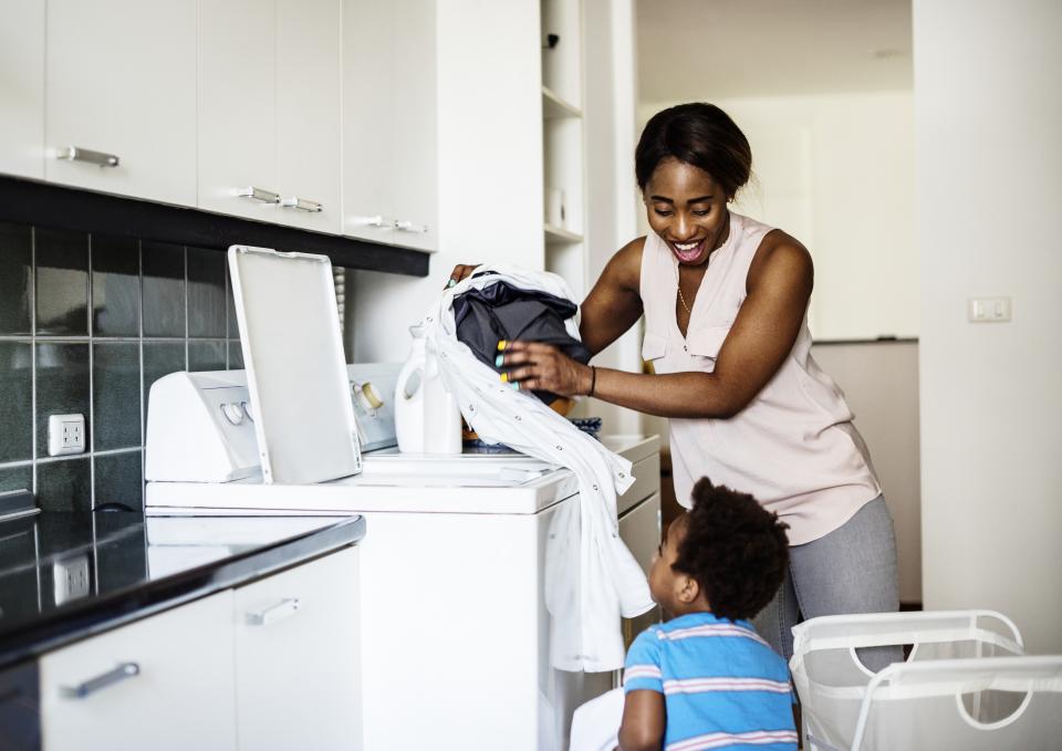 Mother and son doing laundry together