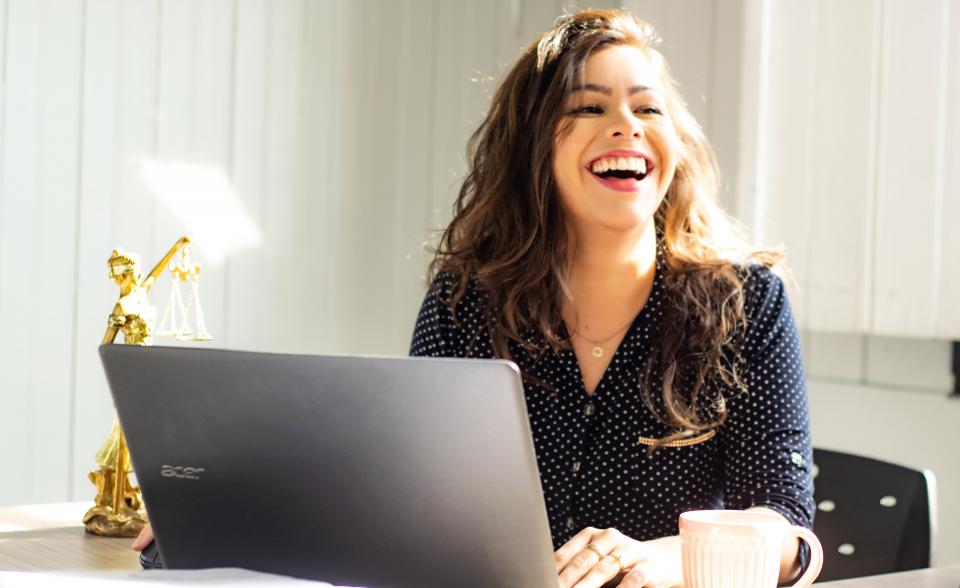 woman working on computer and laughing