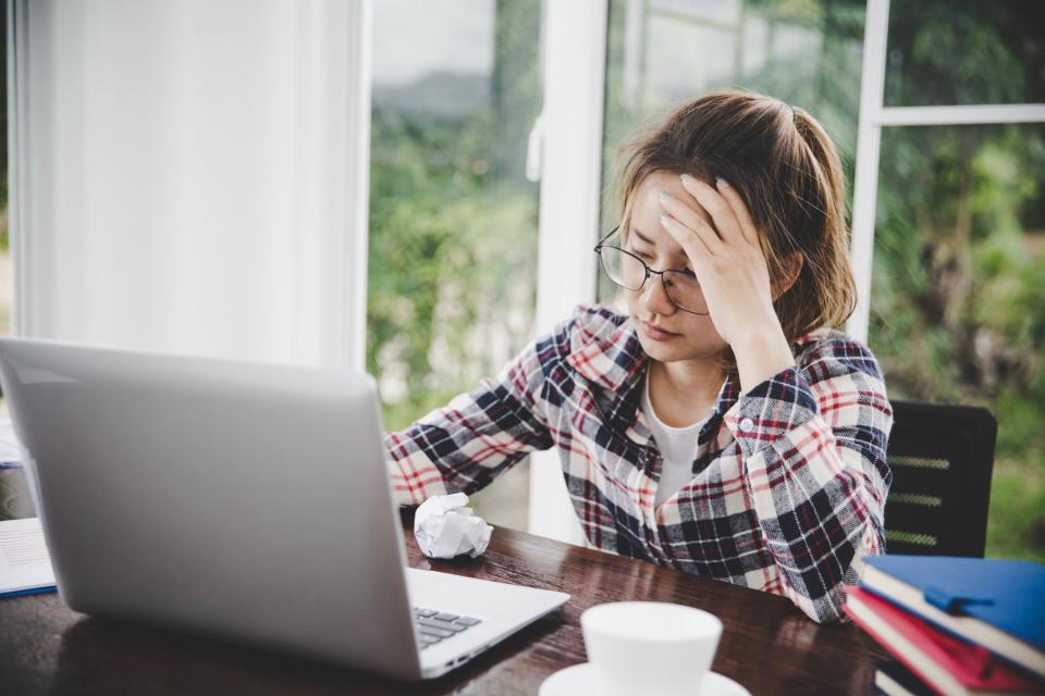 Serious woman on laptop.