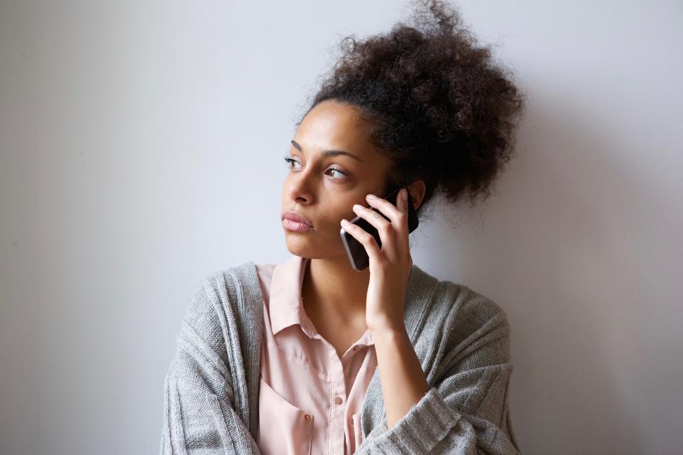 Serious woman on phone.