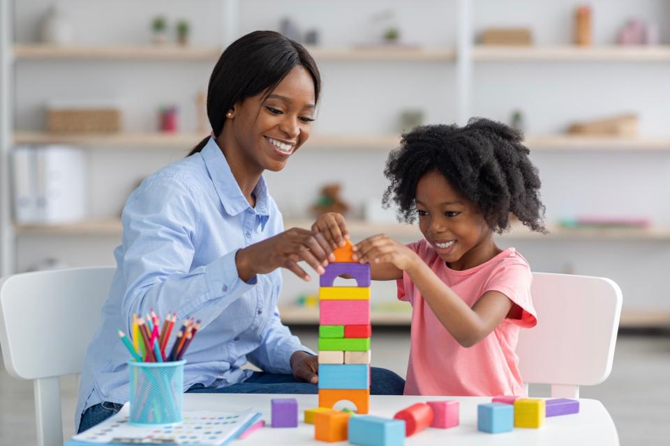 Mom and daughter playing with blocks.
