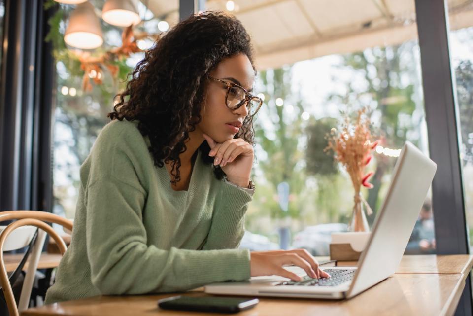 Woman looking at her laptop, concentrating.