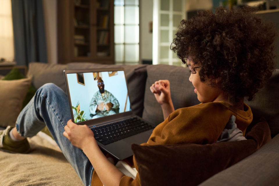 Young boy on a videocall with his father in the military. 