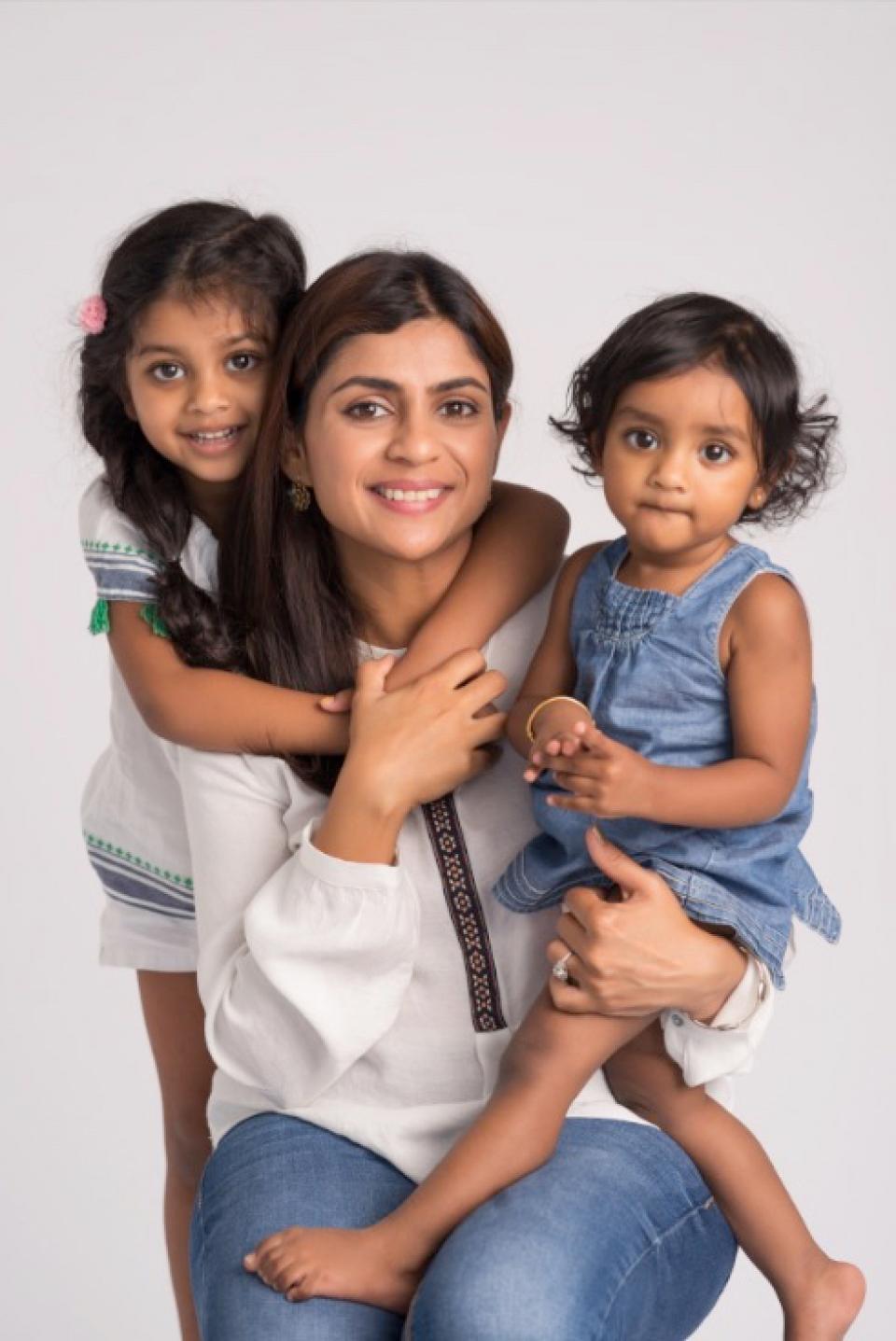 Mom and two daughters posing for family photo